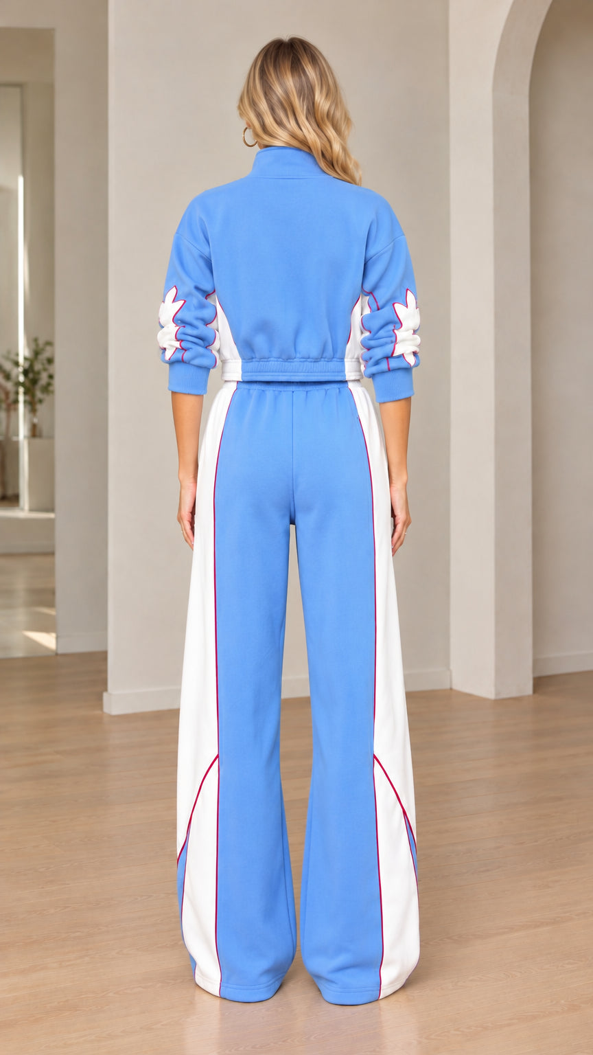 Back view of women's sky blue cropped jacket and wide-leg sweatpants set