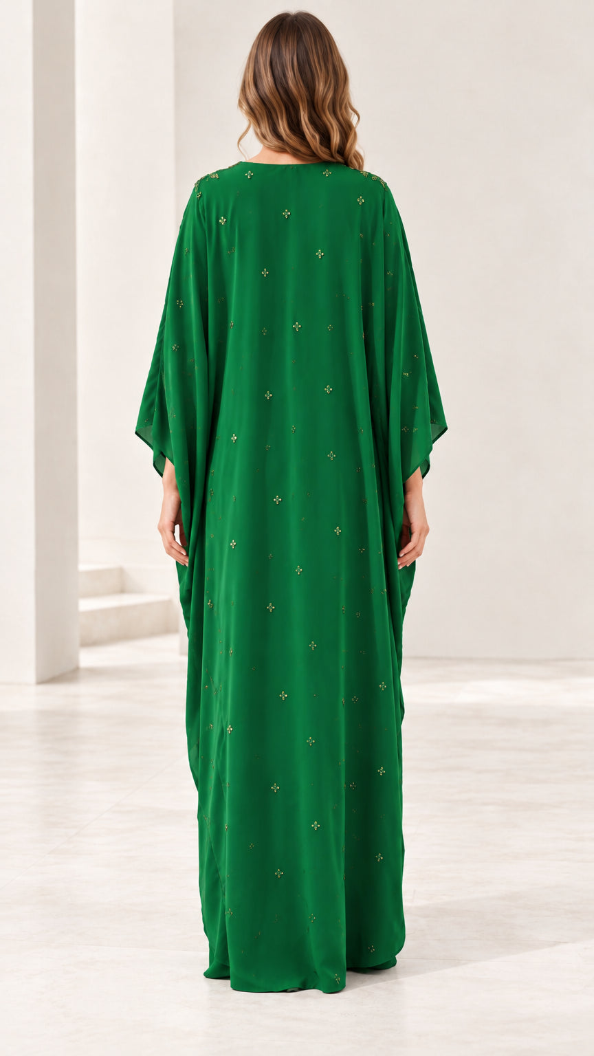 Back view of emerald green kaftan maxi dress showing fluid drape