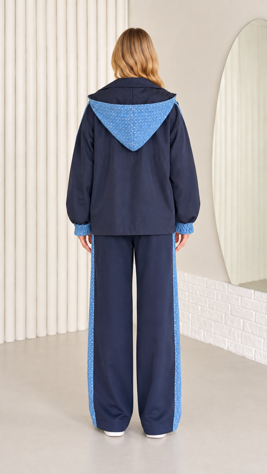 Back view of navy blue hooded jacket with sequin hood detail and matching pants