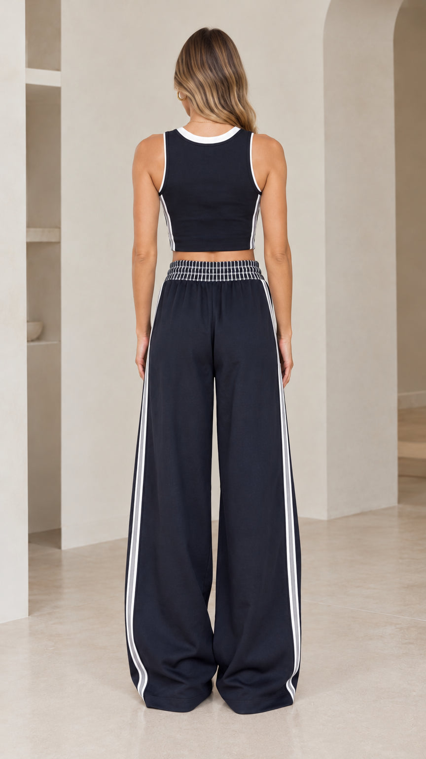 Back view of model wearing Navy Blue sporty two-piece loungewear set