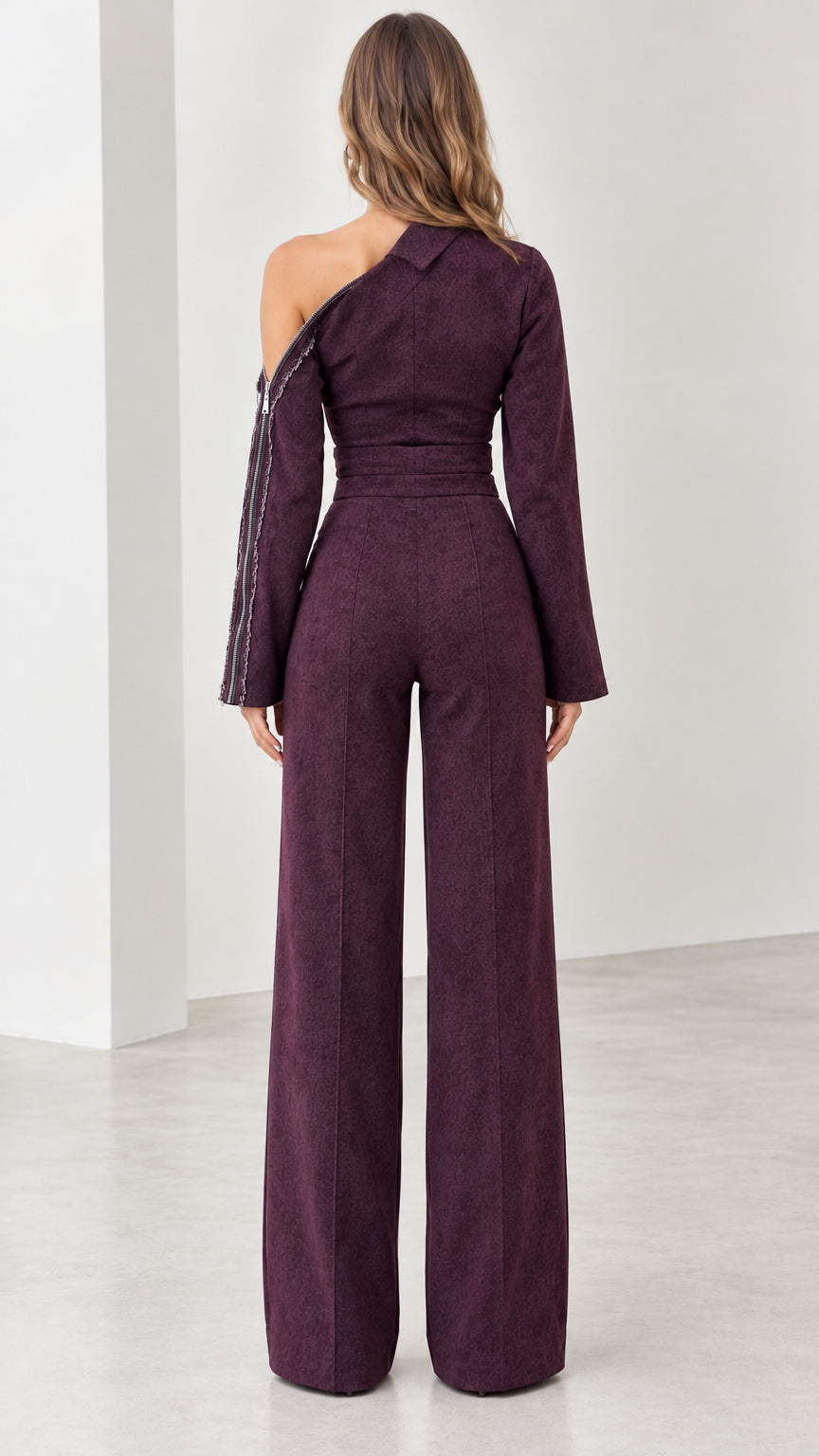Back view of model showcasing tailored fit of plum one-shoulder jumpsuit