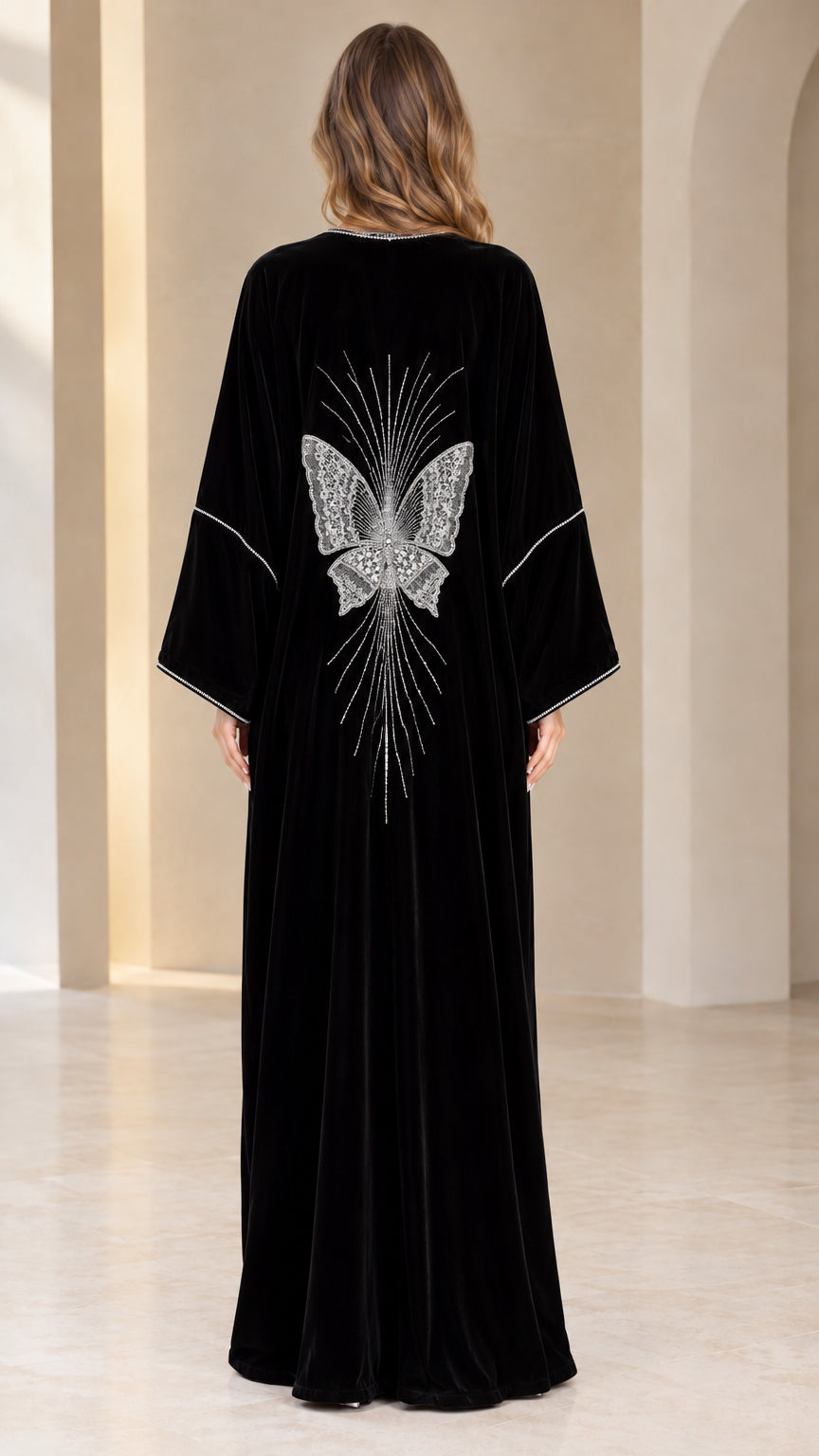 Back view of black velvet abaya featuring a detailed crystal butterfly design