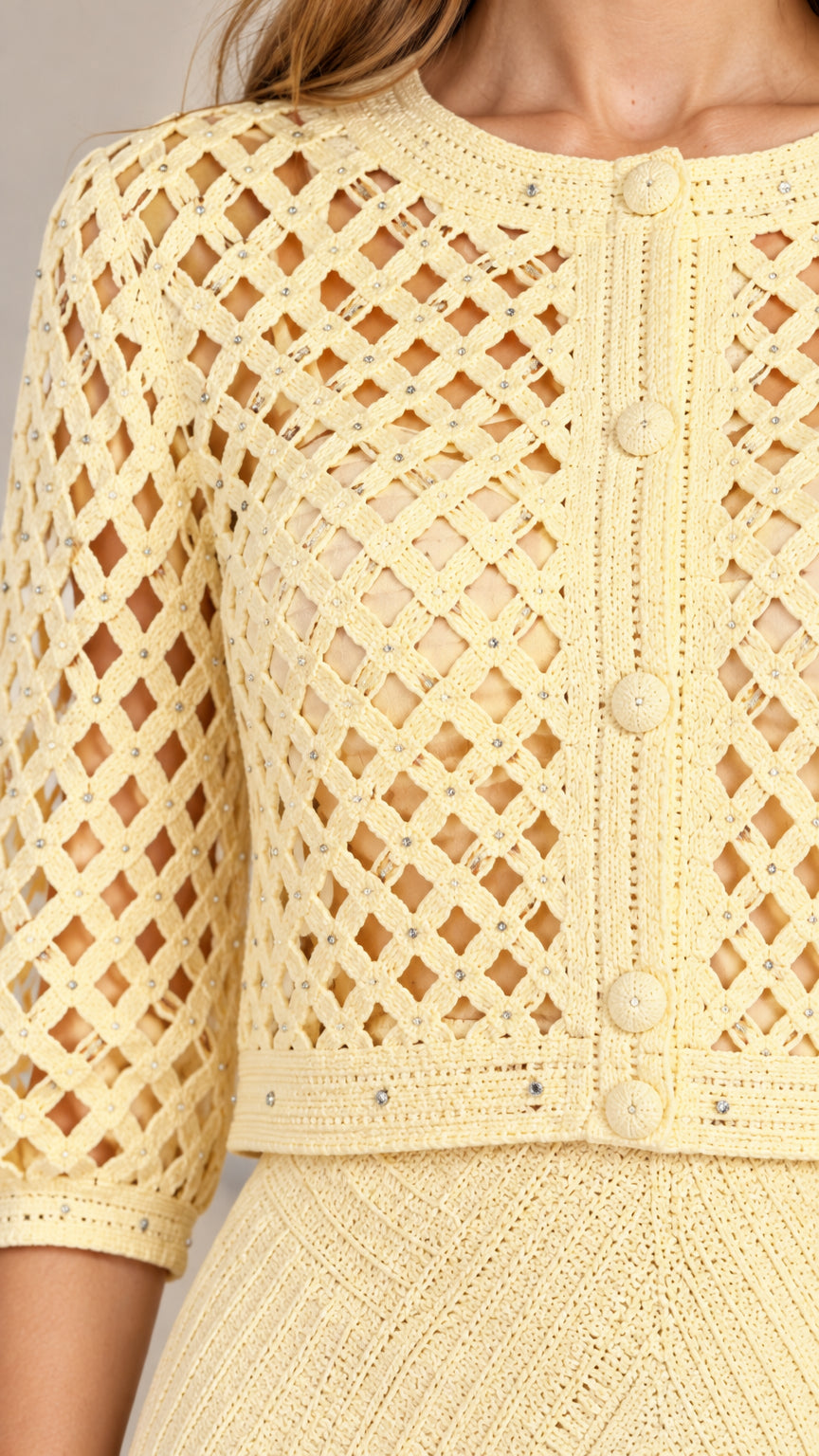 Close-up detail of geometric lattice knit pattern and button accents