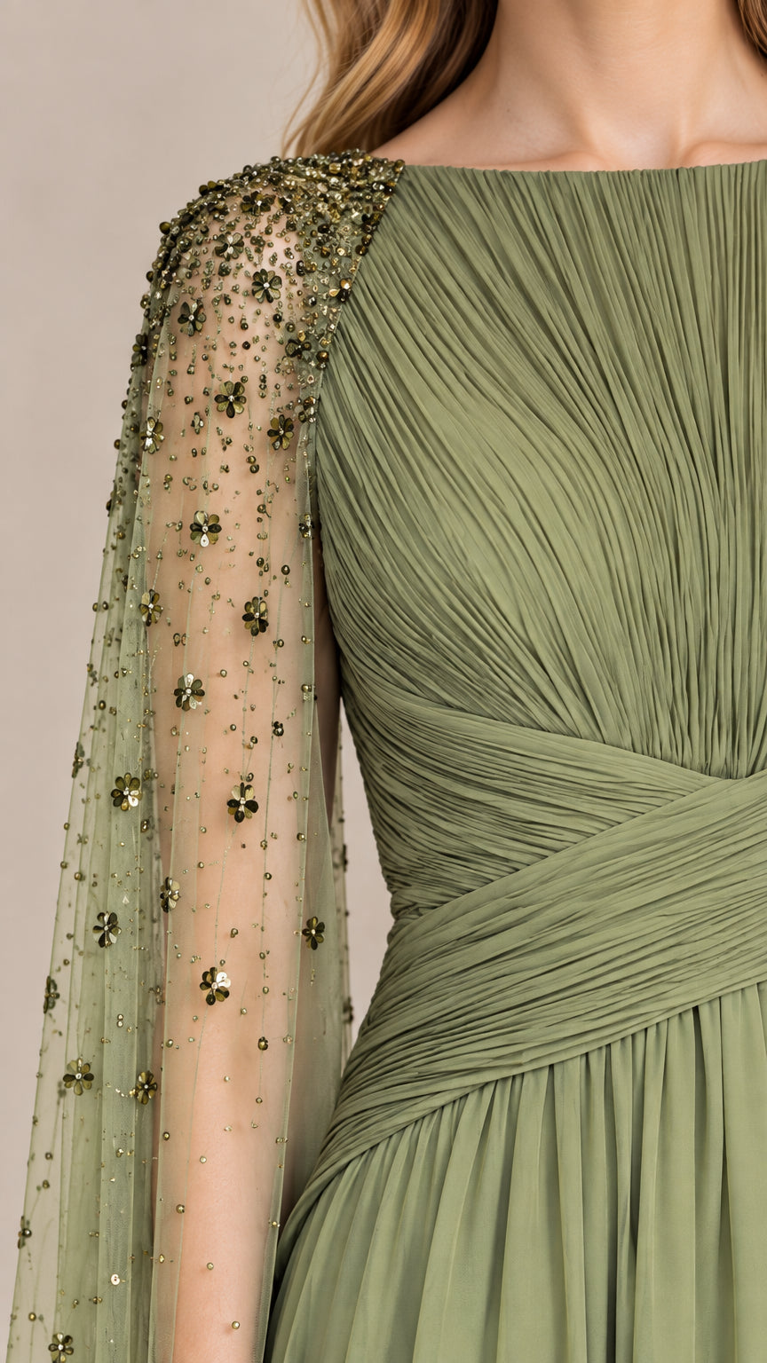 Close-up detail of pleating and beaded embellishments on cape sleeve