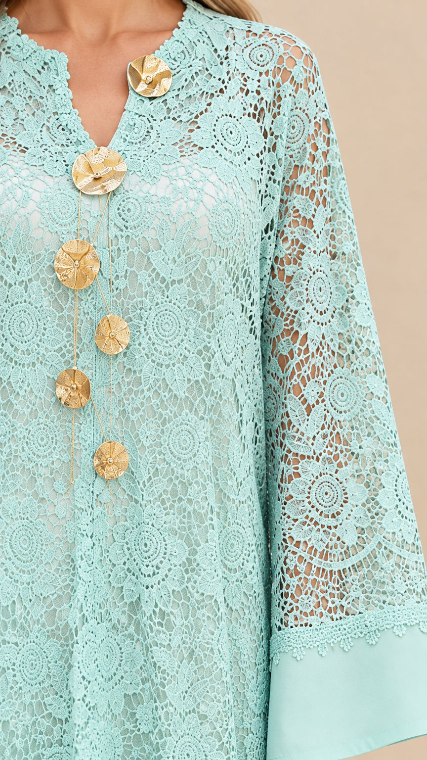 Close-up of Mint Green floral lace pattern and gold flower medallion embellishments