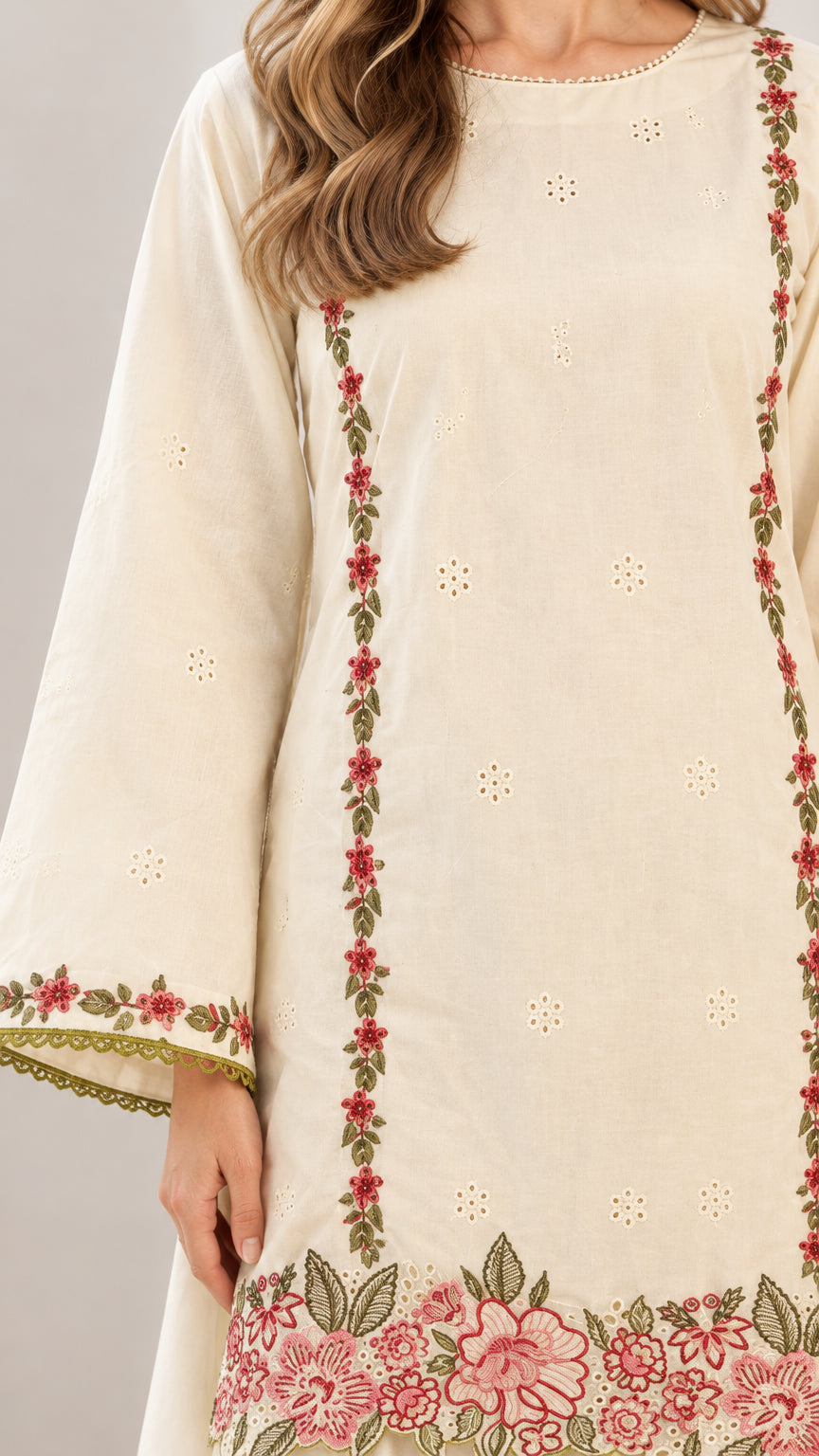Close-up detail of floral embroidery on off-white long sleeve tunic