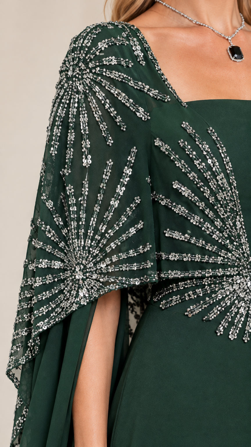 Close-up of intricate starburst sequin and bead embellishments on emerald capelet