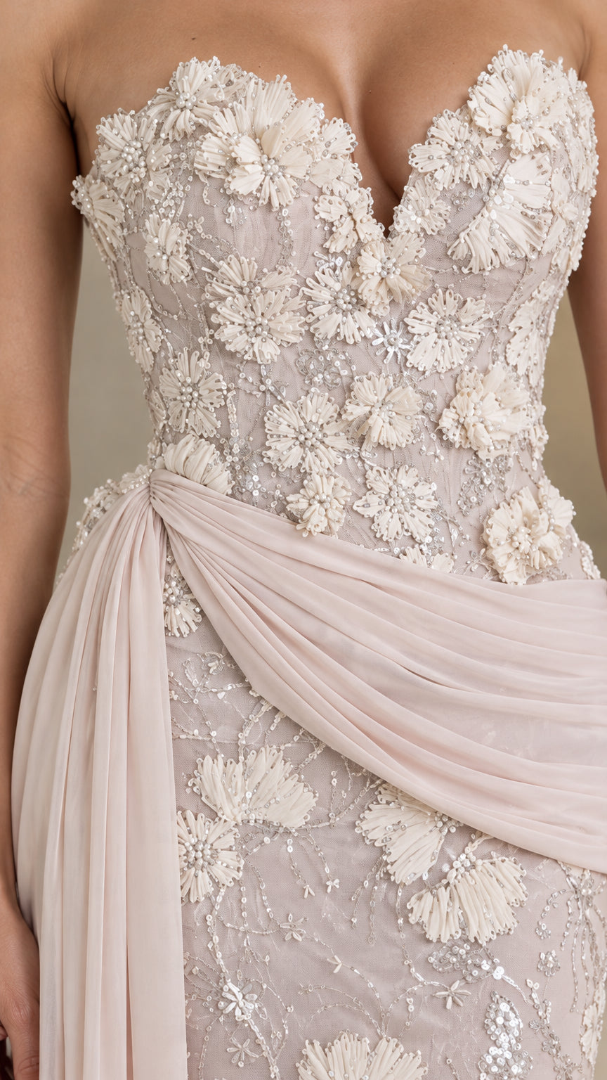 Close-up detail of sweetheart bodice with 3D floral appliqués and gathered chiffon sash