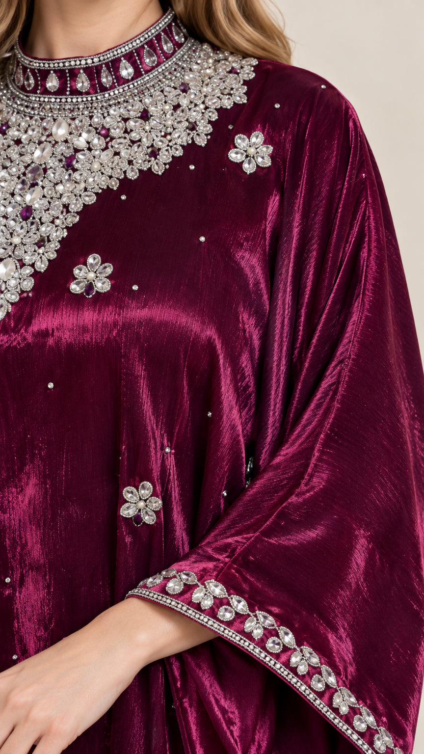 Close-up detail of silver rhinestone and crystal embroidery on burgundy velvet neckline and cuff