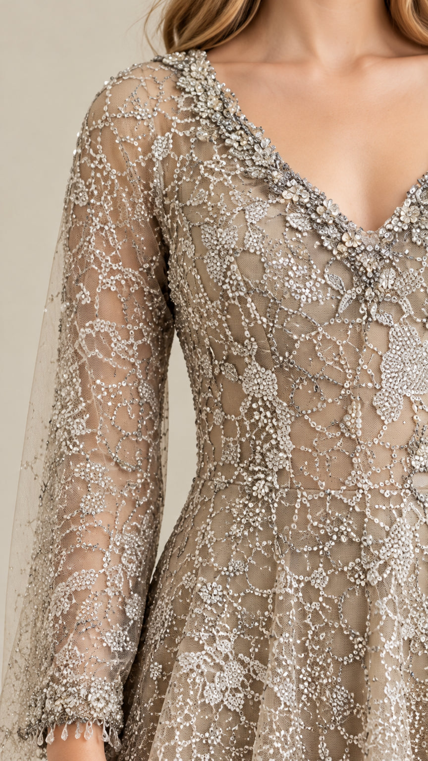 Close-up of intricate silver beadwork, V-neckline, and sheer embroidered sleeve