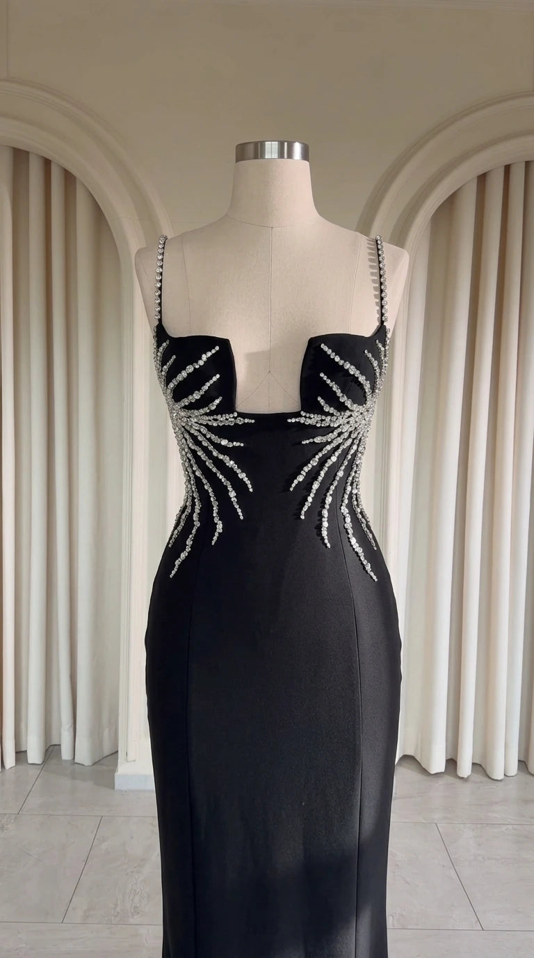 Close up of black evening dress structured notched neckline with crystal rhinestone embellishments on mannequin