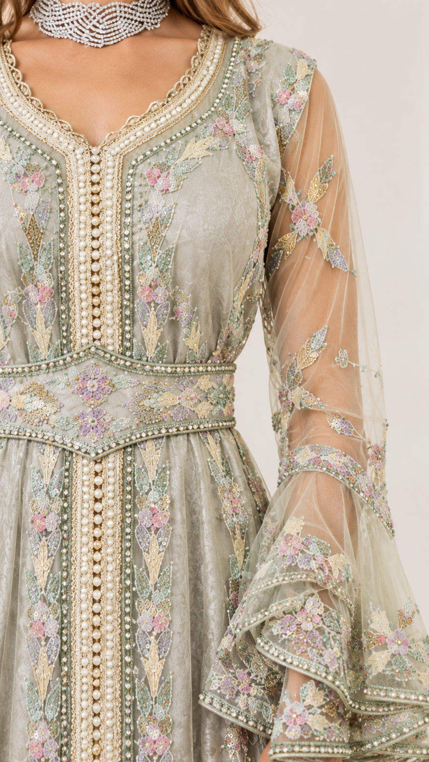 Detailed close-up of beaded neckline, embroidered waist belt, and tiered bell sleeve cuff