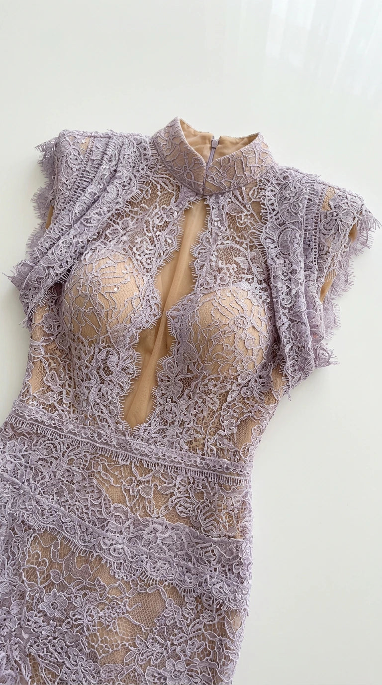Close-up flat lay detail of lavender lace evening gown showing high collar and plunge neckline