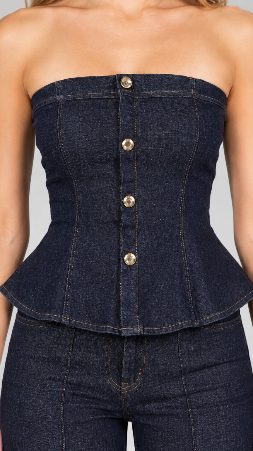 Close-up detail of dark blue strapless peplum top with metallic button front