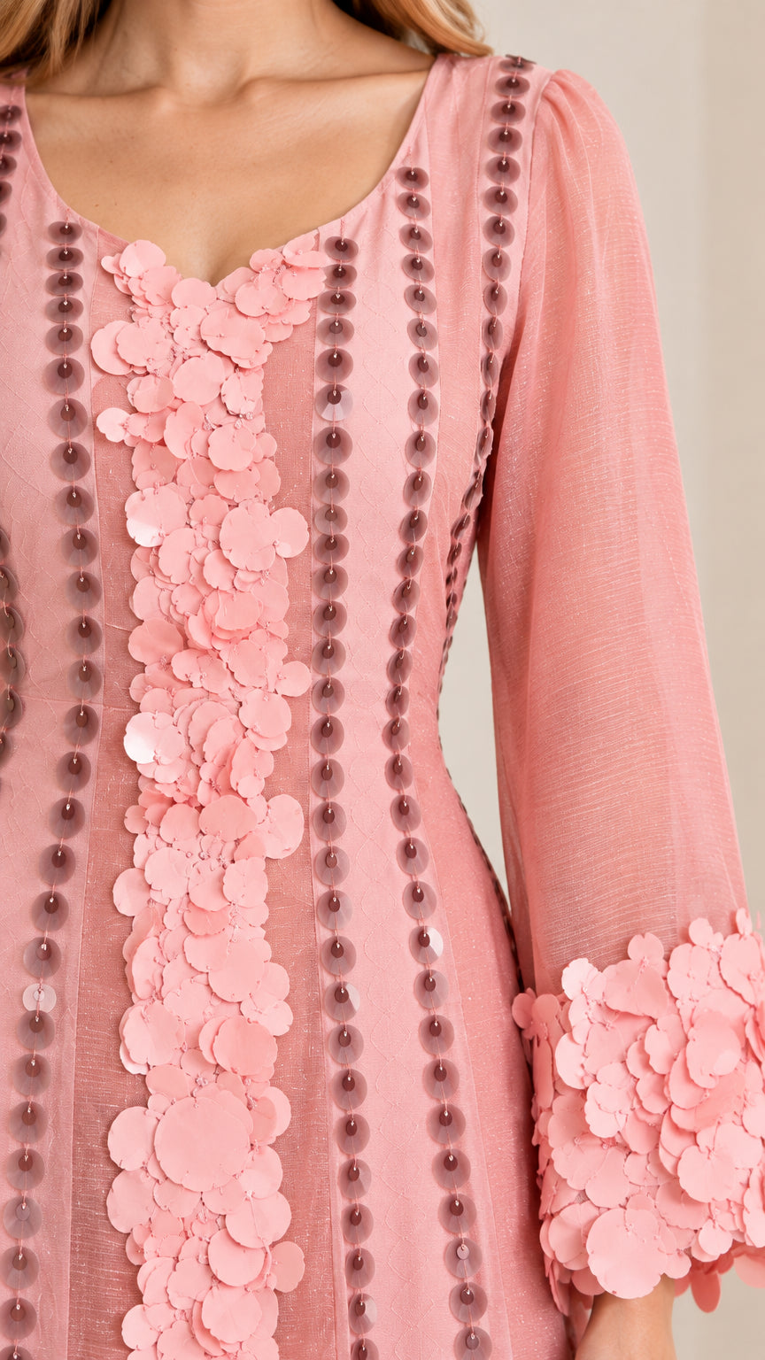 Close-up detail of 3D floral petal applique, scoop neckline, and vertical beadwork