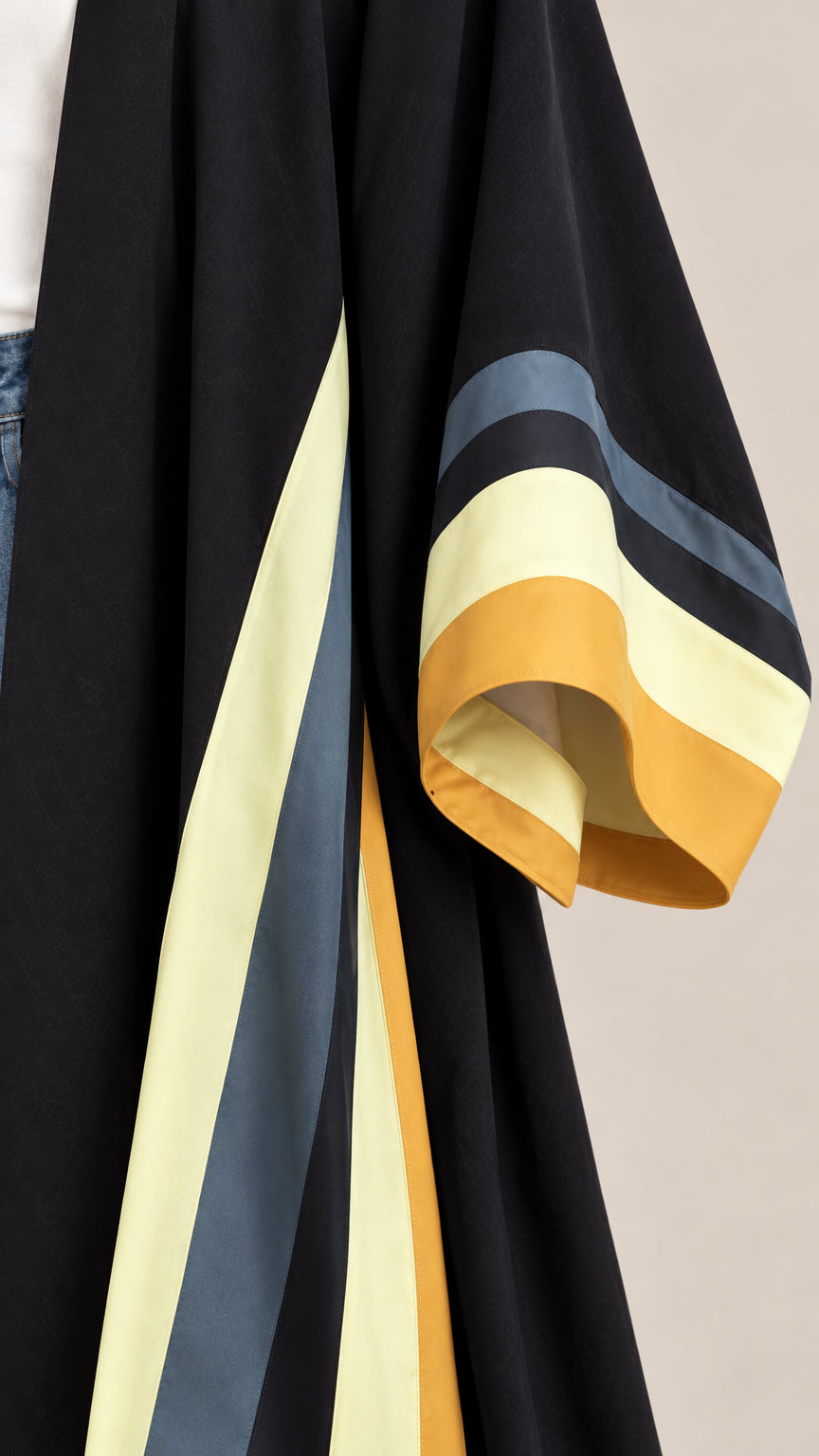 Close-up detail of wide kimono sleeve cuff with yellow and blue colorblock trim