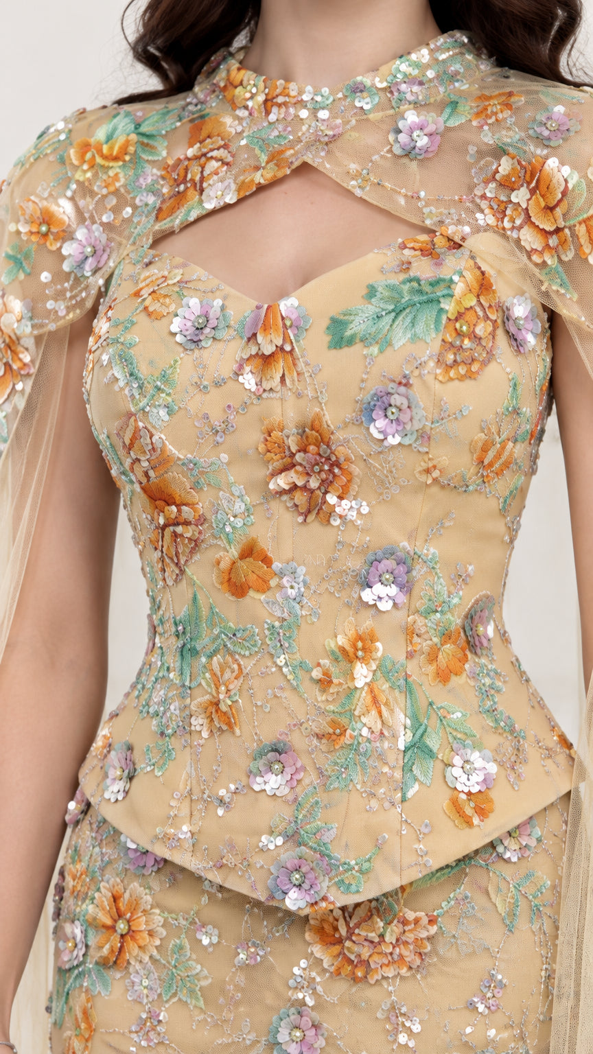 Close-up detail of floral sequin embroidery and keyhole neckline on Champagne evening dress
