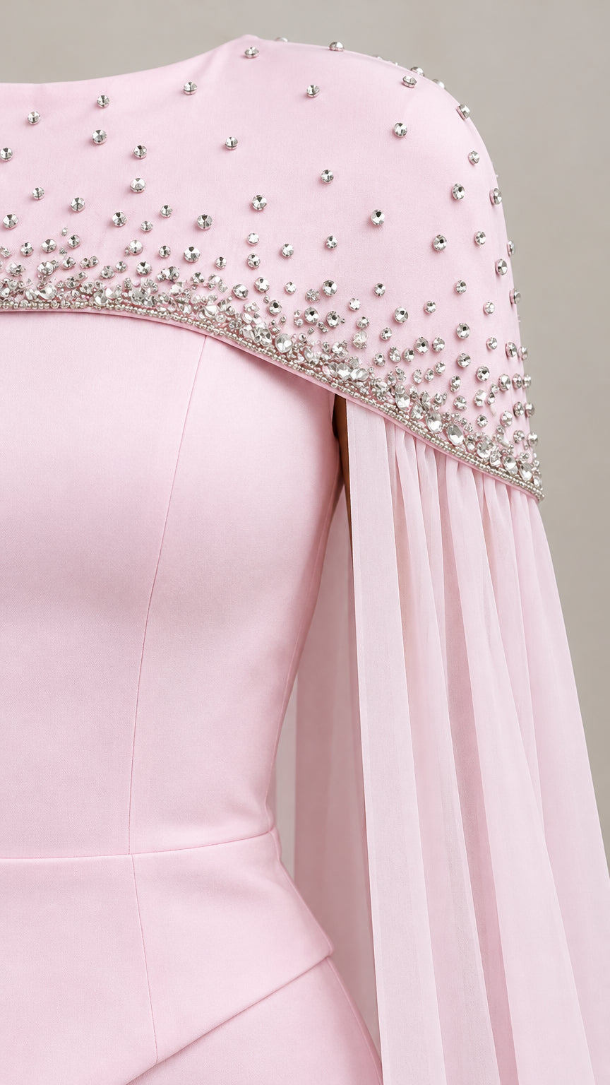 Close up detail of sparkling rhinestones on the shoulder and hem of the cape