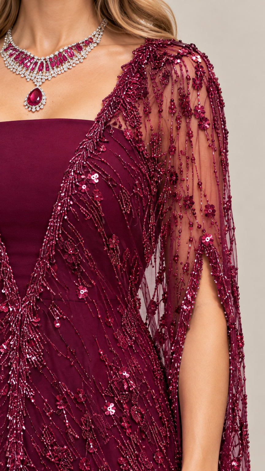 Close-up detail of sheer burgundy sequin cape embroidery and neckline