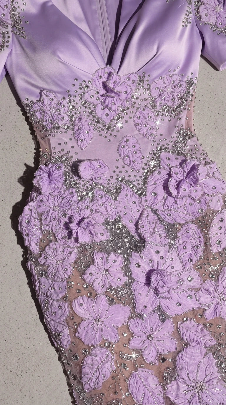 Close-up detail of 3D floral appliqués and crystal embellishments on bodice and waist