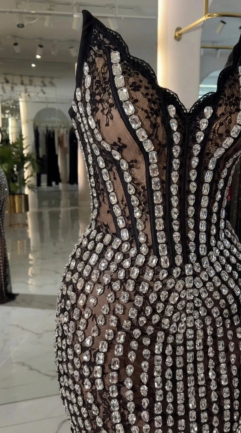 Close-up detail of sheer corset boning, floral lace, and radiant rhinestones