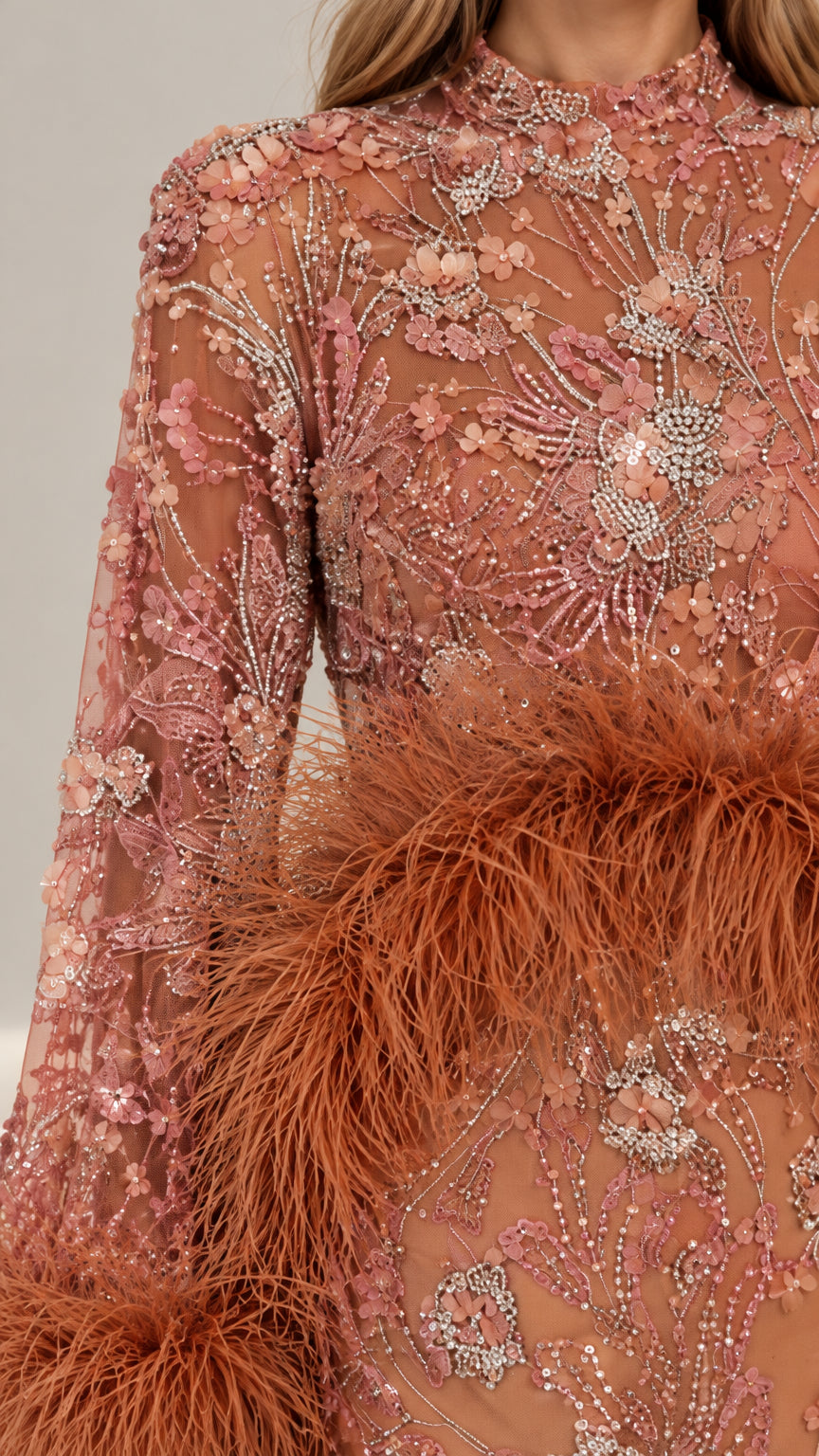 Close-up detail of intricate floral sequin embroidery and textured feather trim