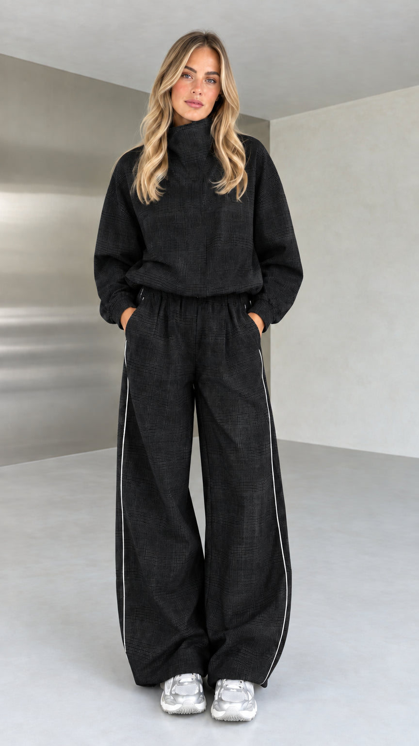 Model wearing black plaid high-neck top and wide-leg matching set