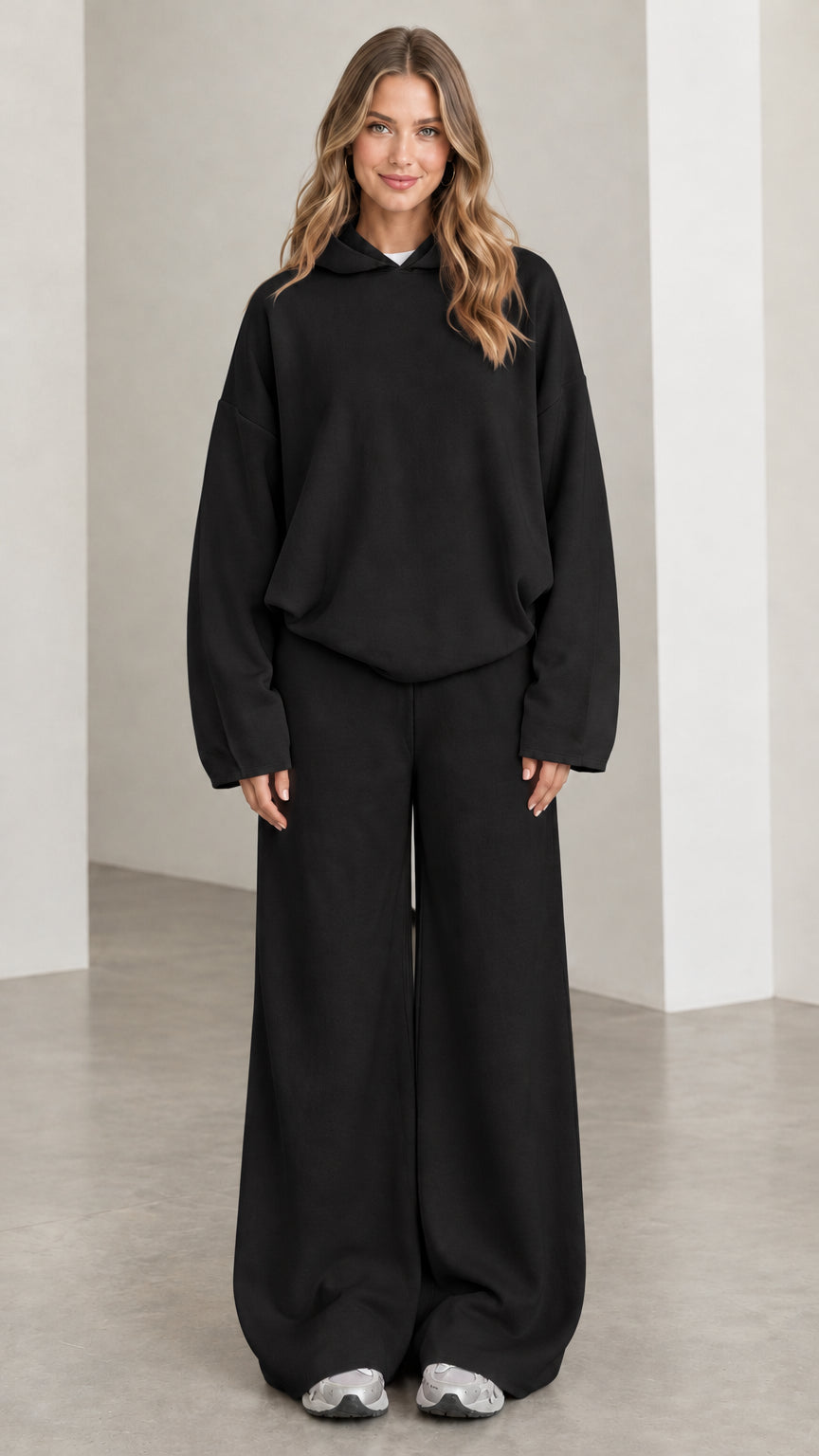 Front view of woman wearing Black oversized hoodie and wide leg pants lounge set