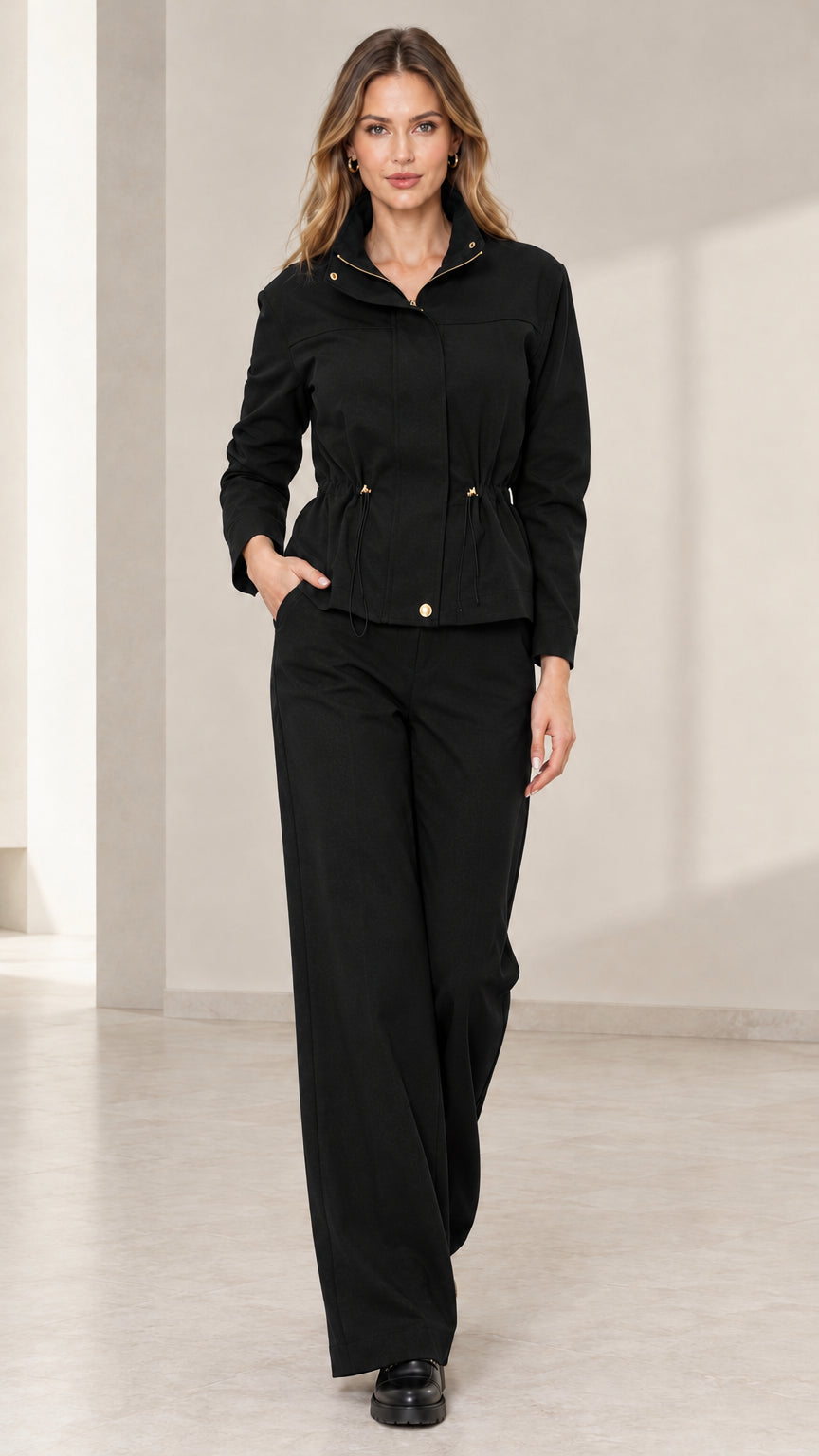 Model wearing Black utility jacket and matching wide-leg trousers set
