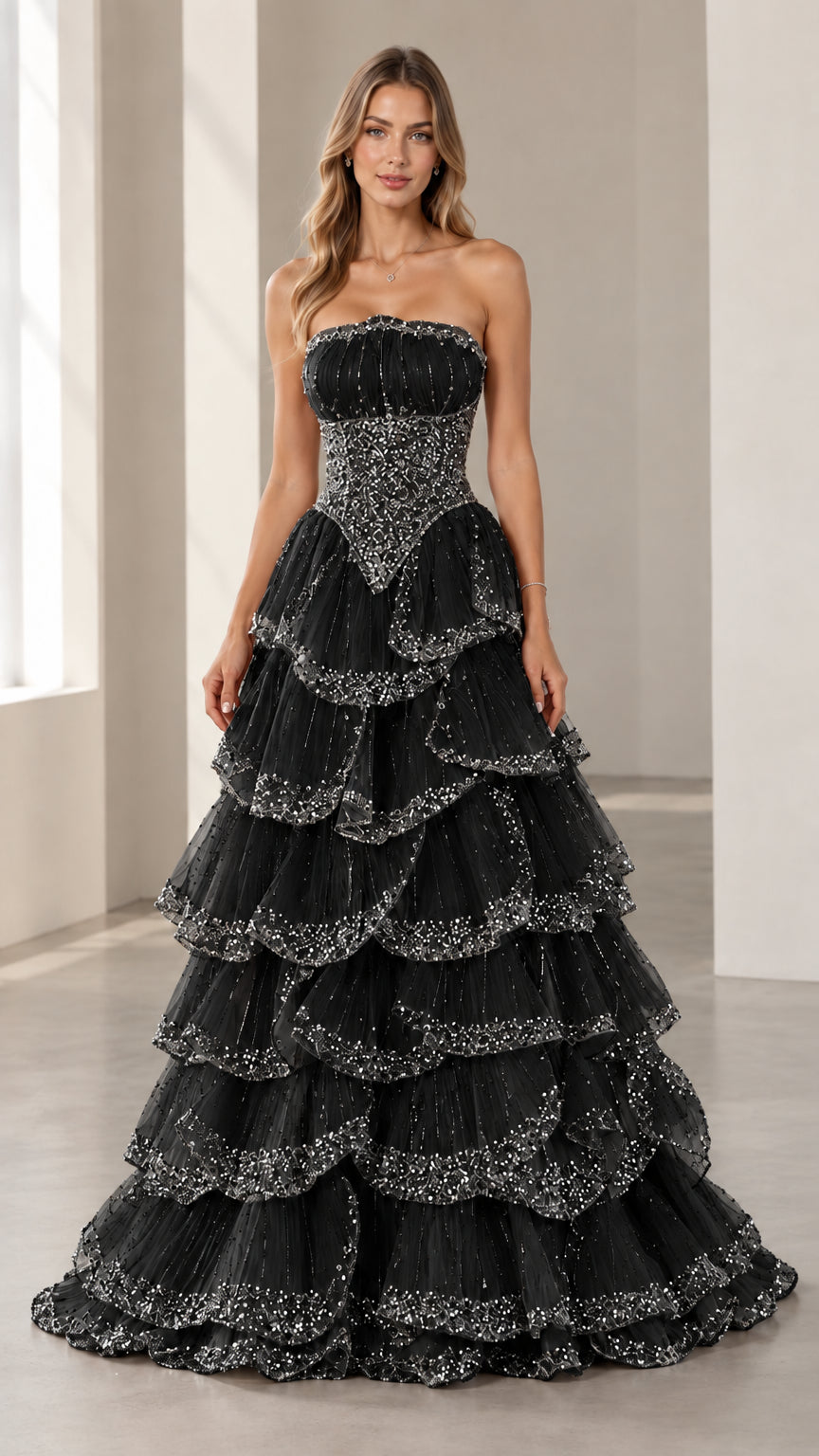 Full-length front view of the strapless beaded tiered evening gown in Black