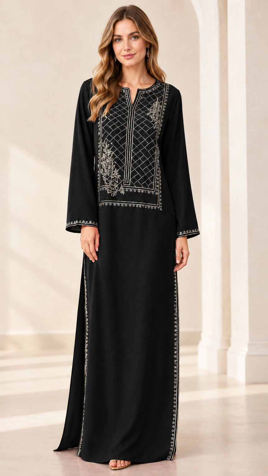 Front full view of woman wearing black embroidered kaftan maxi dress