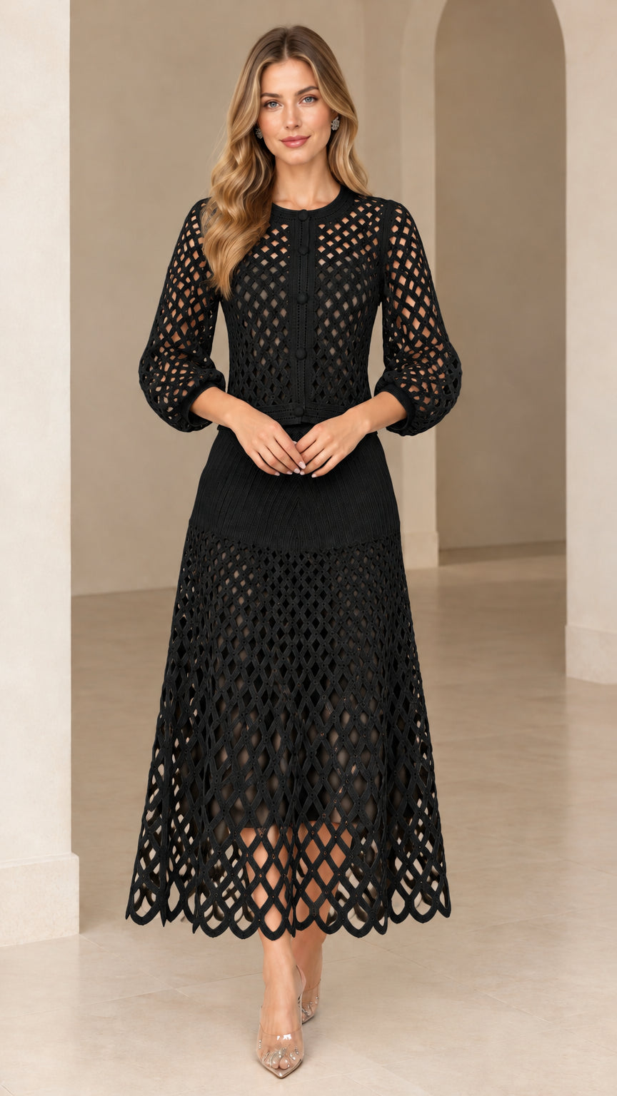 Model wearing black lattice openwork knit top and midi skirt set