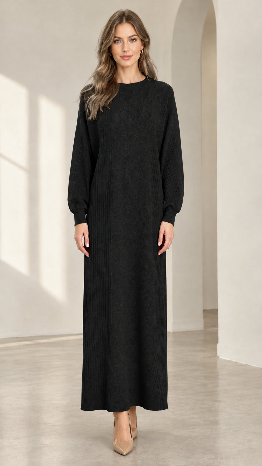 Front view of woman wearing black textured knit long sleeve maxi dress
