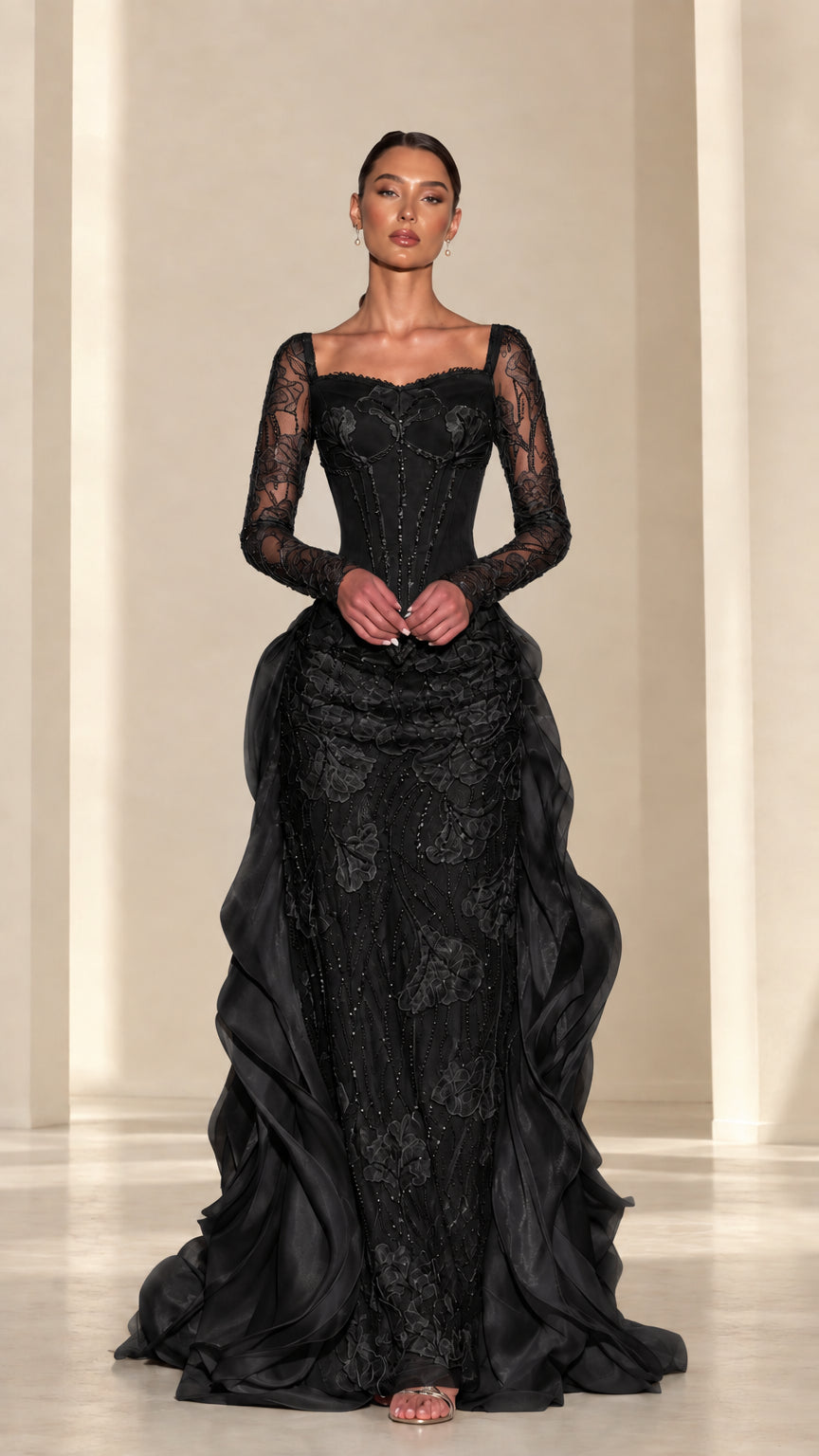 Front view of black embroidered corset evening gown with cascading ruffles