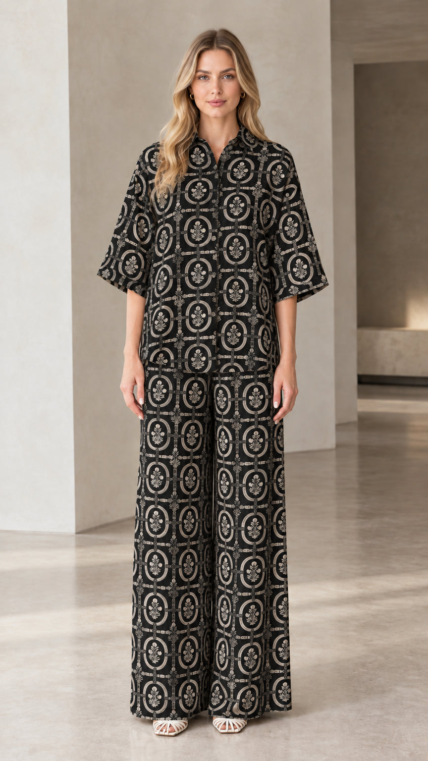 Full front view of woman wearing black vintage medallion print two-piece matching set