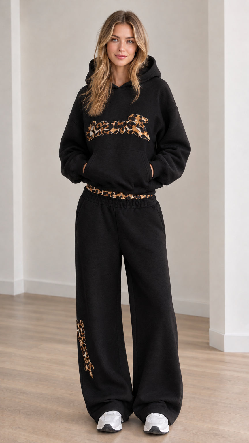 Front view of model wearing the lounge set in Black with leopard trim accents