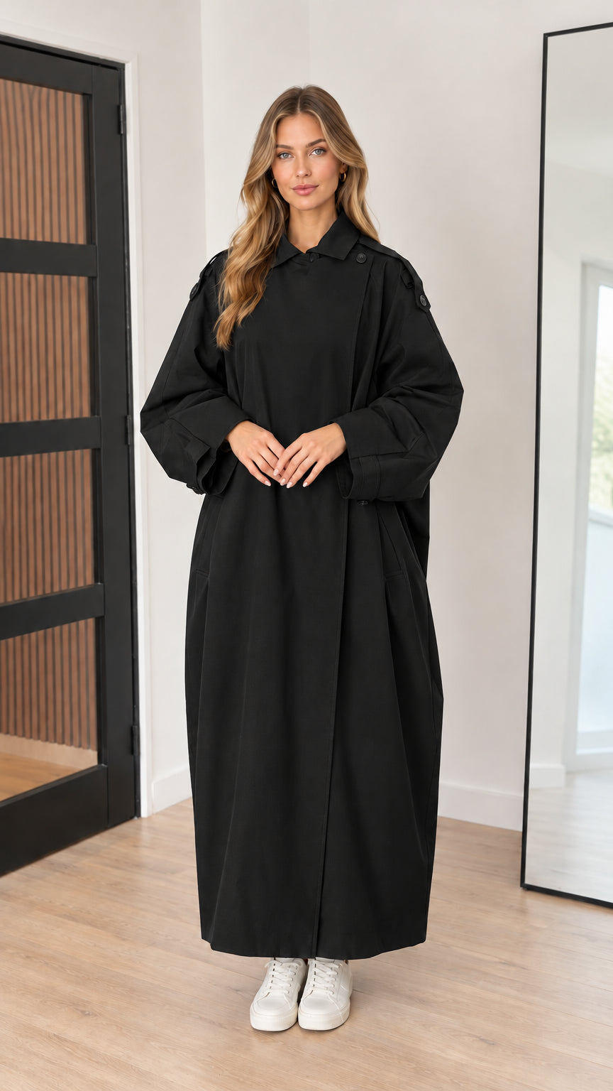 Full-length front view of black oversized maxi trench coat on model