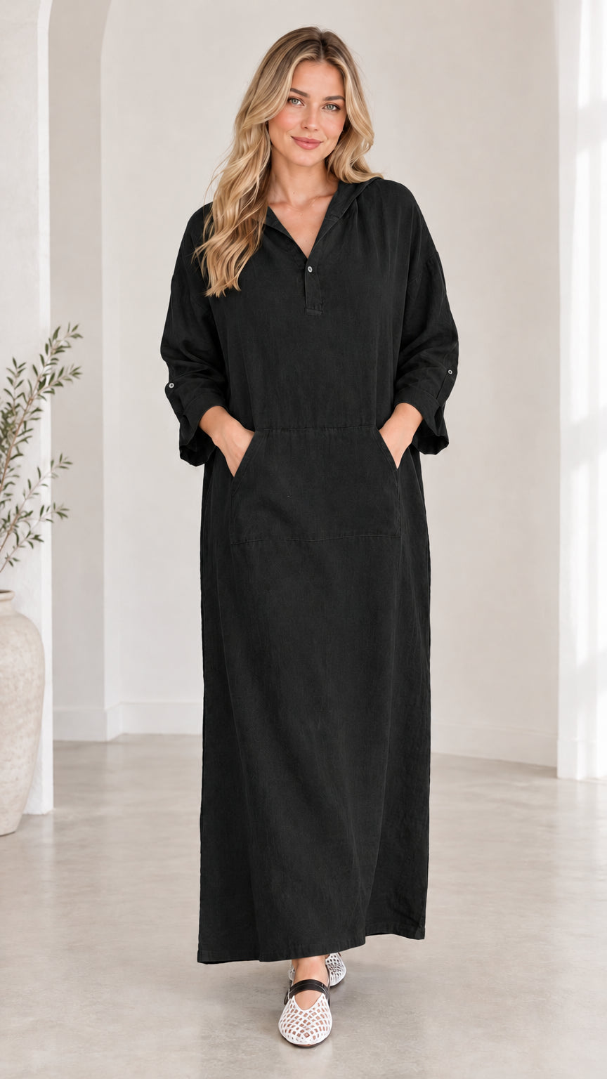 Front view of woman wearing black casual hooded maxi dress