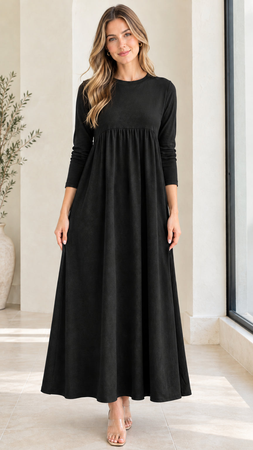 Front view of model wearing black long sleeve empire waist maxi dress