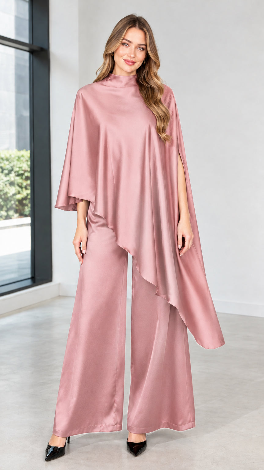 Model wearing dusty pink satin mock neck cape top and matching wide-leg pants