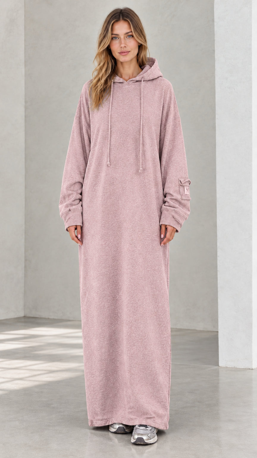 Front view of model wearing dusty pink oversized maxi hoodie dress