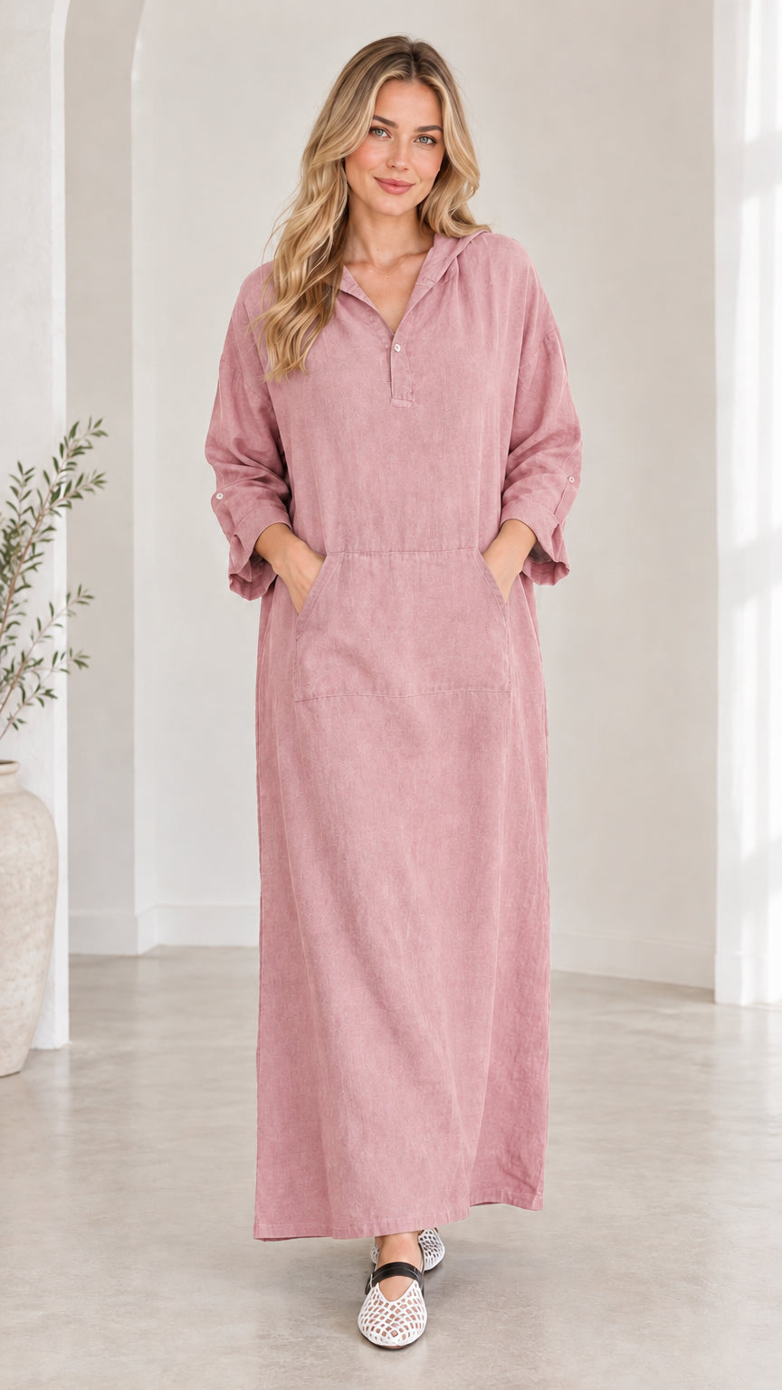 Front view of woman wearing dusty pink hooded maxi dress