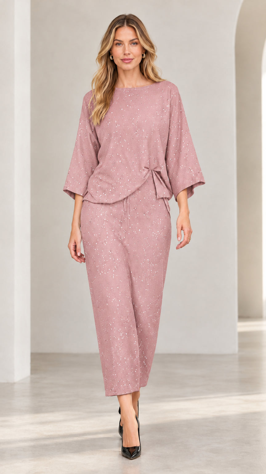 Model wearing dusty rose shimmer speckled two-piece matching top and pant set