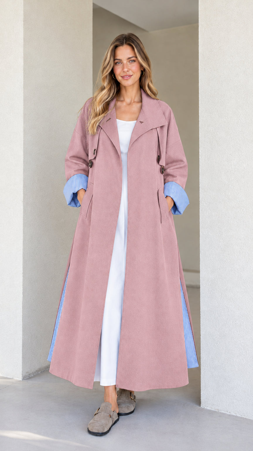 Model wearing the maxi trench duster in dusty pink with blue striped turn-up cuffs