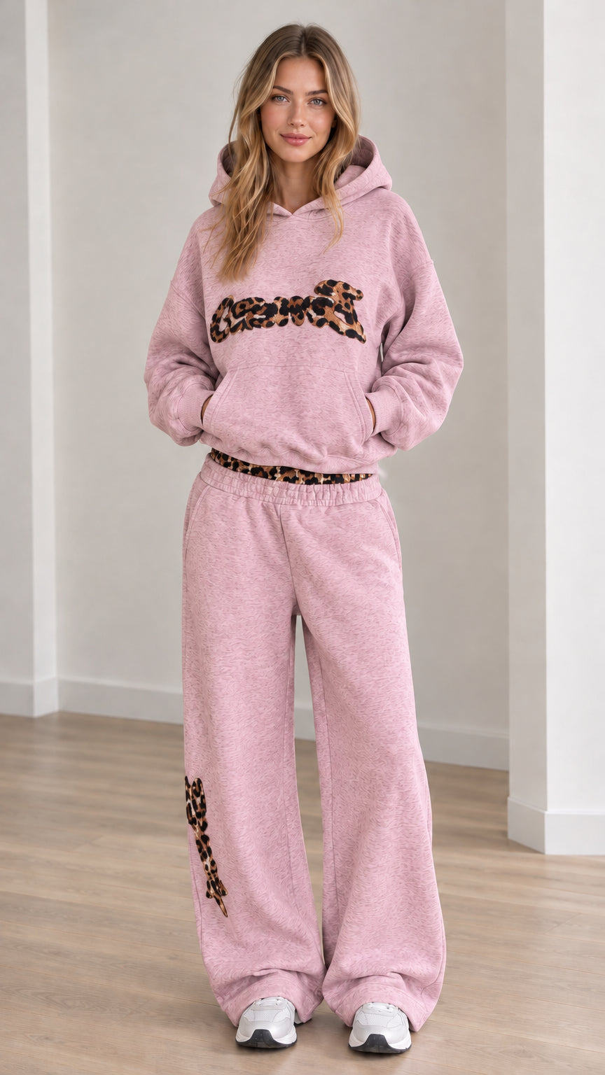 Front view of model wearing the lounge set in Pink with leopard chest appliqué