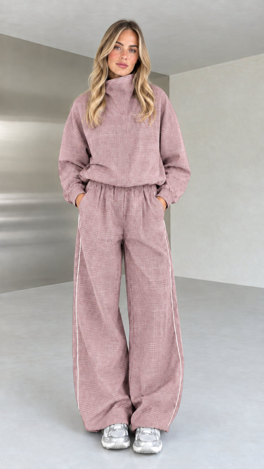 Model wearing dusty pink plaid high-neck top and wide-leg trousers set