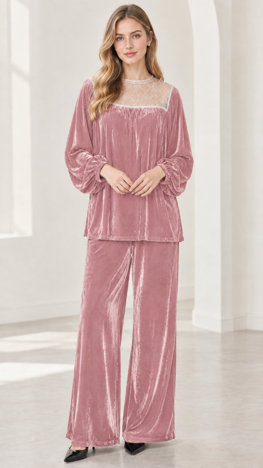 Full-length view of model wearing dusty rose pink velvet two-piece pant set