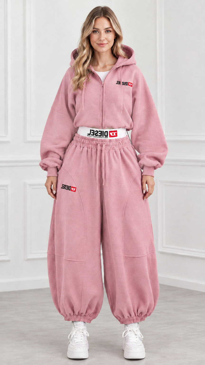 Front view of model wearing dusty pink cropped zip hoodie and sweatpants set