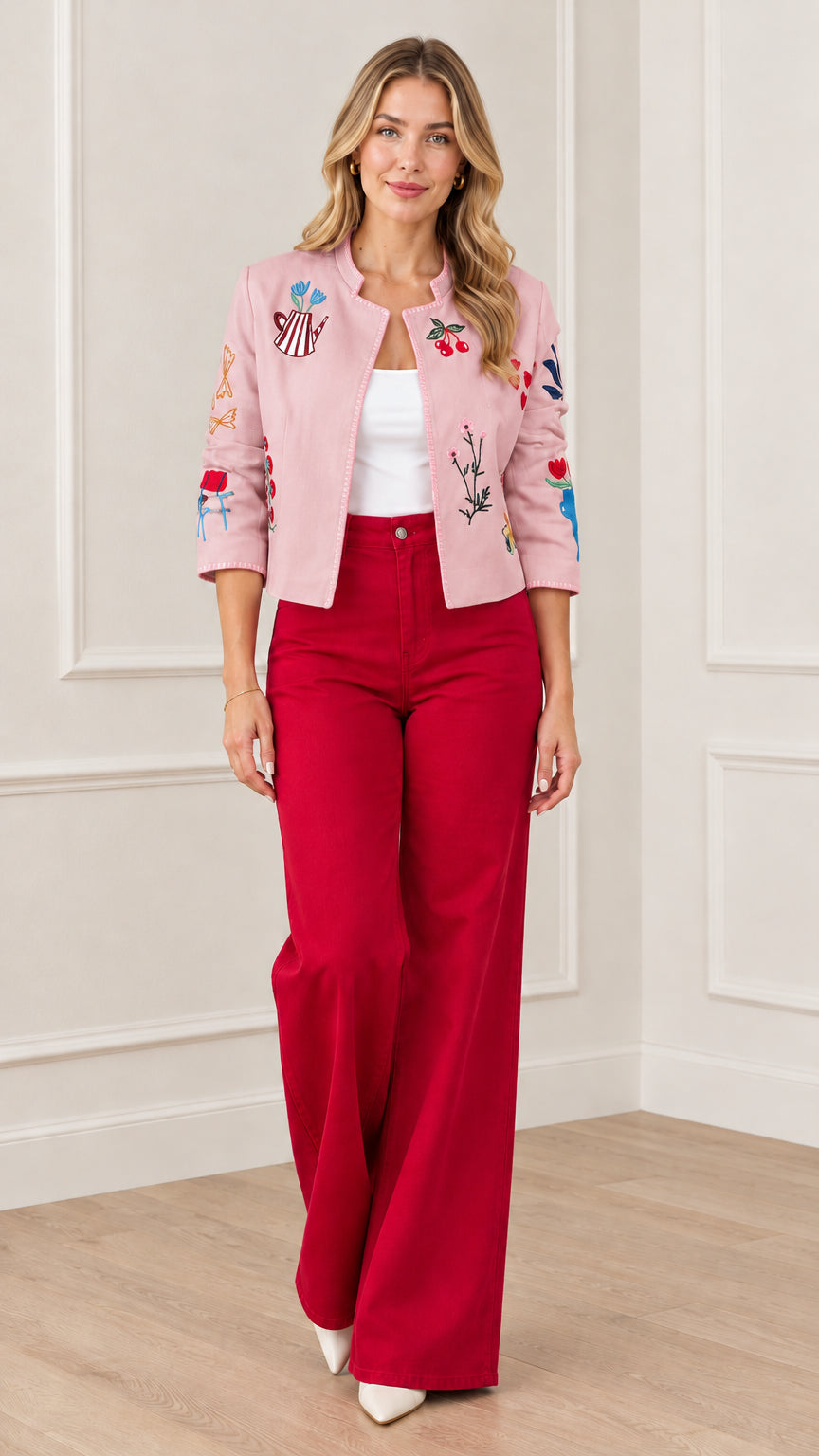 Pink whimsical embroidered open front cropped jacket styled with red trousers