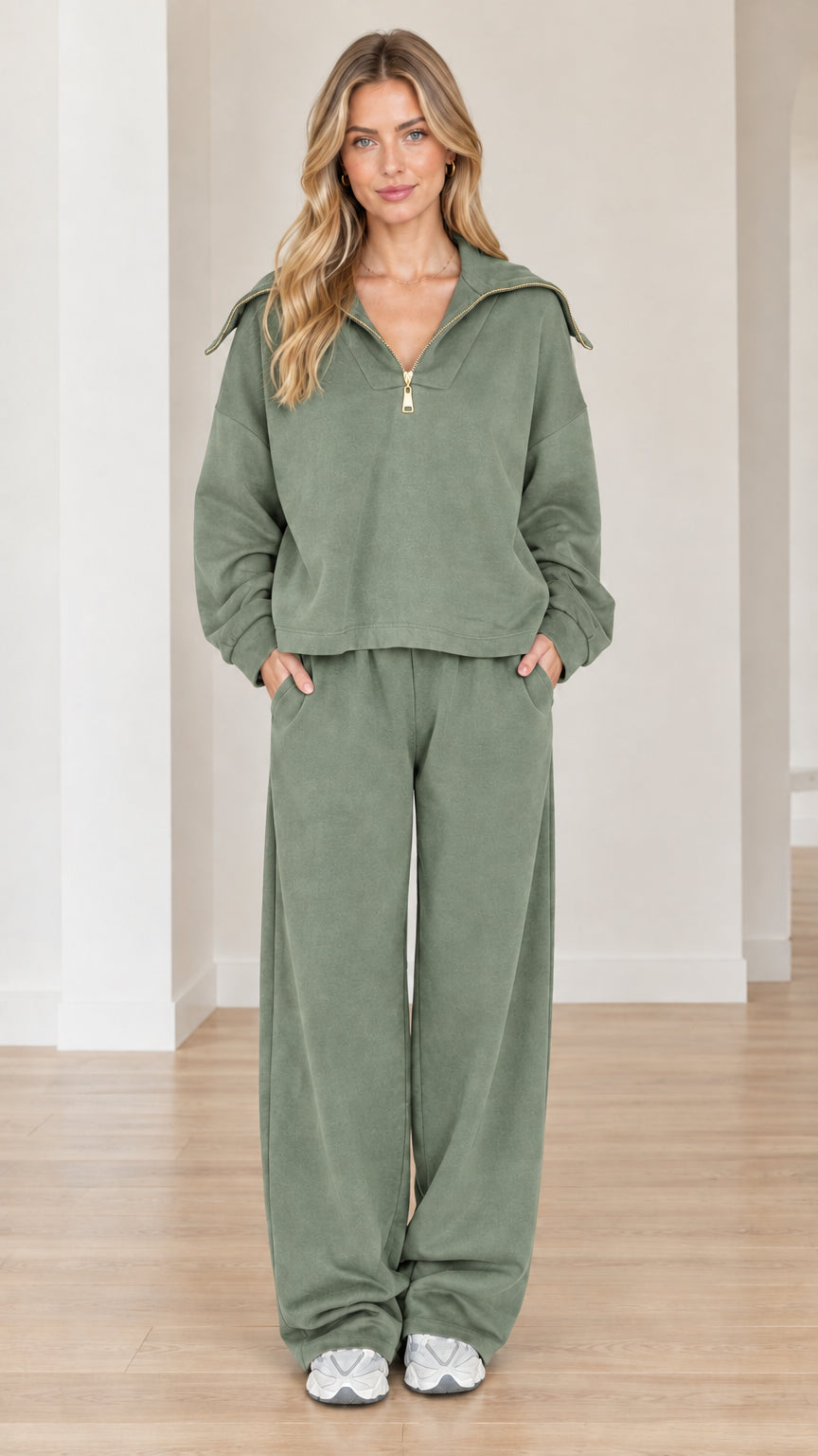 Model wearing sage green two-piece half-zip sweatsuit with wide-leg pants